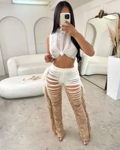 Trendy white fringe knitted two-piece set featuring sleeveless crop top and tassel pants
