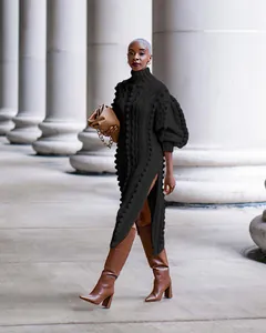 Elegant black high-neck knit maxi dress featuring side slit and stylish puff sleeves