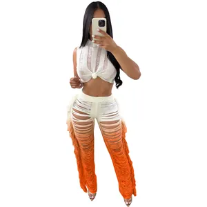 Detail showing the intricate orange gradient fringed texture on wide leg pants set