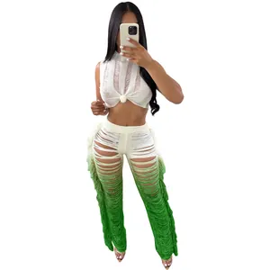 Close-up detail of white knit sleeveless crop top and green ombre fringed pants set