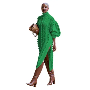 Detail view of a green cable knit high neck dress with side slits and bubble sleeves