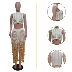 Detail view of two-piece set featuring a knot crop top and distressed gradient pants