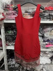 Detail view of red bodycon dress with beaded fringe and shimmering crystal accents