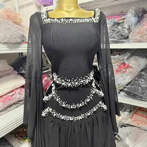 Elegant black long-sleeve party dress featuring pearl embellishments and a slim fit design