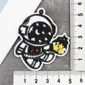 Detailopname van een schattige geborduurde astronautenstrijkpatch met meetlatten