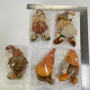 Five harvest-themed plush scarecrows and gnomes shown with a professional measurement ruler