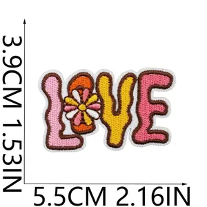 Close-up view of bohemian LOVE embroidered patch with measurements in cm and inches