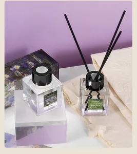 Close-up detail of cocoiris reed diffuser glass bottles and packaging box on elegant linen