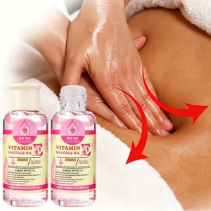 Two bottles of DKDE Vitamin E massage oil being applied for a soothing body massage
