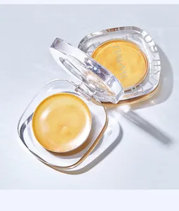 Close-up of TIANWEI golden multi-use makeup balm in transparent packaging