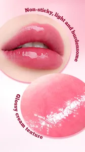 Macro detail of glossy pink lip glaze showing a shimmering cream texture