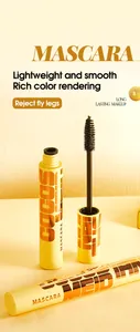 Close-up of black volumizing mascara brush and sleek golden tube for long lasting makeup