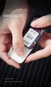 Macro detail of portable long-lasting solid perfume balm for men in a matte metal sliding tin