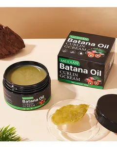 Vue détaillée de la texture de la crème bouclante MEIDIAN Batana Oil et son emballage