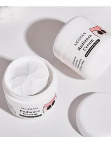 Detailed view of MEIDIÁN Radiance Cream with white flower-like texture and jar packaging