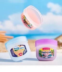 Detailed view of MEIDIAN moisturizing lip balm jars presented in a sunny beach setting