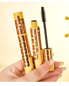 Detail of volumizing mascara wand and yellow tube packaging with metallic text