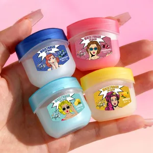 Detailed view of four colorful moisturizing lip balm jars with pop-art labels held in hand