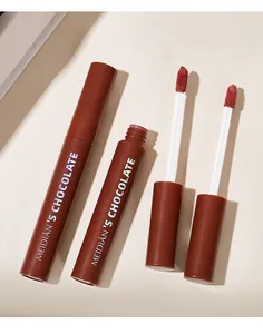 Close-up macro shot of chocolate lip gloss applicators showing rich matte liquid texture