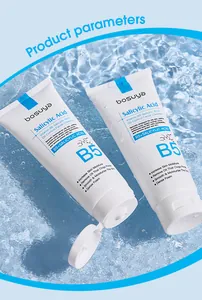 Macro view of two facial cleanser tubes on a refreshing blue water and ice texture background
