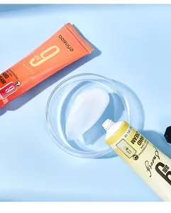 Macro view of white cream texture and packaging of Bosuya hydrating hand cream tubes.