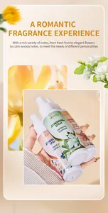 Macro view of ADMD long-lasting fragrance spray bottles held in hand with floral decor