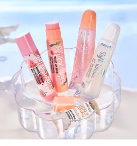 Close-up of BOSUYA hydrating lip balm and pearlescent lip oil tubes in a glass bowl