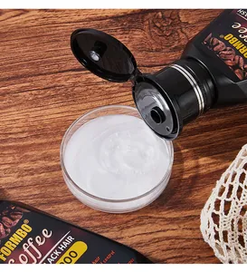 Close-up of white creamy coffee shampoo texture being poured into a dish.