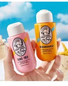 Close-up of two 90ml FORMBO perfume body wash travel bottles in pink and orange colors.