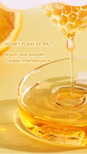 Macro view of honey plant extract liquid dripping into a glass lip balm container