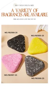 Close-up of four colorful triangular scented soaps in black, pink, yellow, and grey colors.
