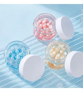 Detailed macro view of FORMBO facial skin care essence cream capsules in glass jars