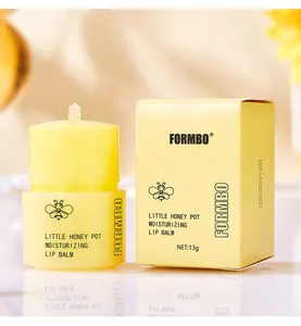 Detailed shot of FORMBO Little Honey Pot Moisturizing Lip Balm and its yellow packaging box
