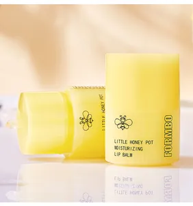 Close-up view of FORMBO Little Honey Pot moisturizing lip balm featuring a cute bee logo design