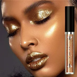 Macro view of gold glitter liquid eyeshadow and lip gloss effect on model's eyelids and lips