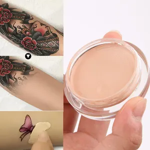Detail shot of high-coverage concealer cream covering a tattoo on skin