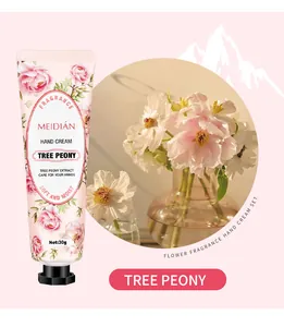 Detailed close-up of MEIDIÁN tree peony fragrance hand cream tube with floral theme