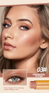 Detail of shimmering orange eyeshadow stick on model for a fresh makeup look.