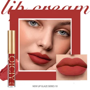 Professional macro shot showing smooth matte red lip glaze texture and vivid finish