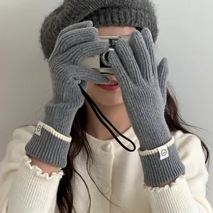 Cozy grey winter knitted gloves featuring contrast trim and a cute hello label detail