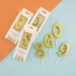 Elegant gold number candles for birthday party cake decoration in individual boxes