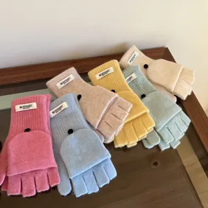 Close-up detail showing the texture of various colored wool flip-top fingerless gloves