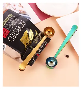 Detailed view of gold and iridescent stainless steel coffee scoop with bag sealer clip