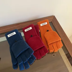 Detailed view of three pairs of wool flip-top fingerless gloves in blue, red, and orange.