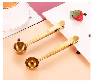 Detailed view of golden 304 stainless steel coffee measuring spoons with bag sealing clips