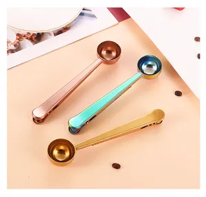 Three stainless steel coffee spoons with clips in rose gold, rainbow, and gold finishes.
