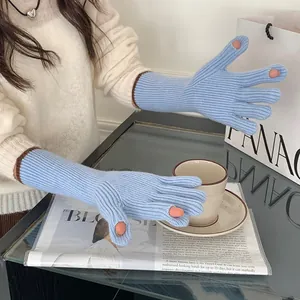 Detail view of light blue ribbed knit gloves with finger holes for touchscreens