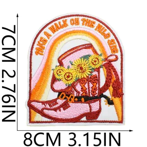 Macro size detail of embroidered pink cowboy boot patch with sunflowers and wild side