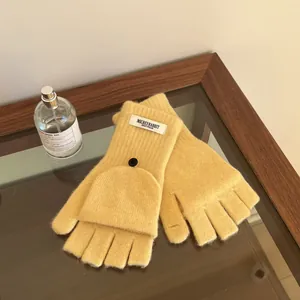 Detailed view of yellow wool fingerless knit gloves with a convenient fold-over flap