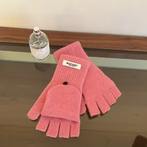 Detailed view of pink 100% wool convertible knitted gloves with flip-top design and button